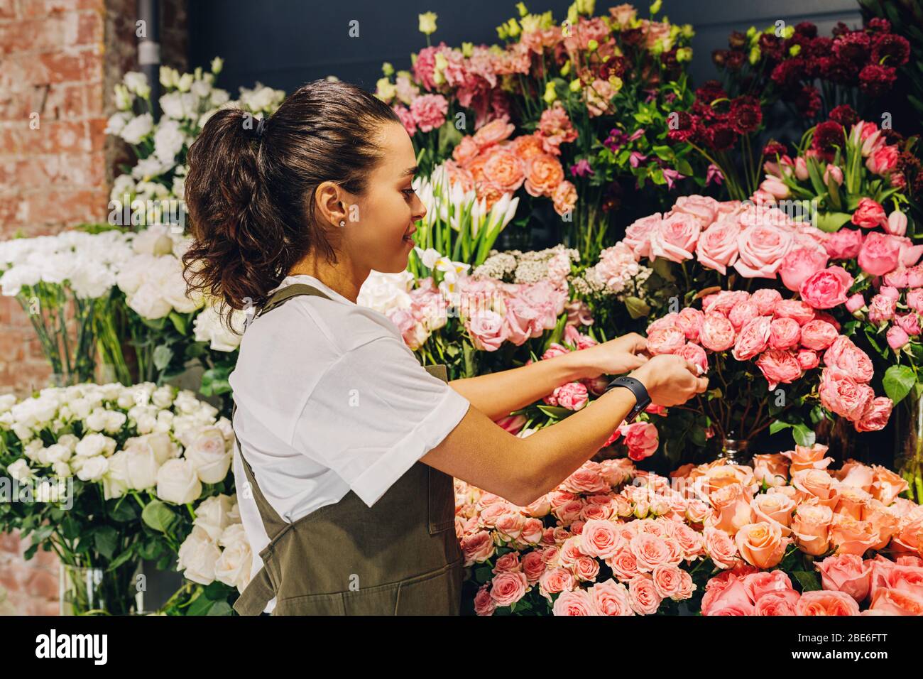Young woman caring for flowers in a flower shop Stock Photo