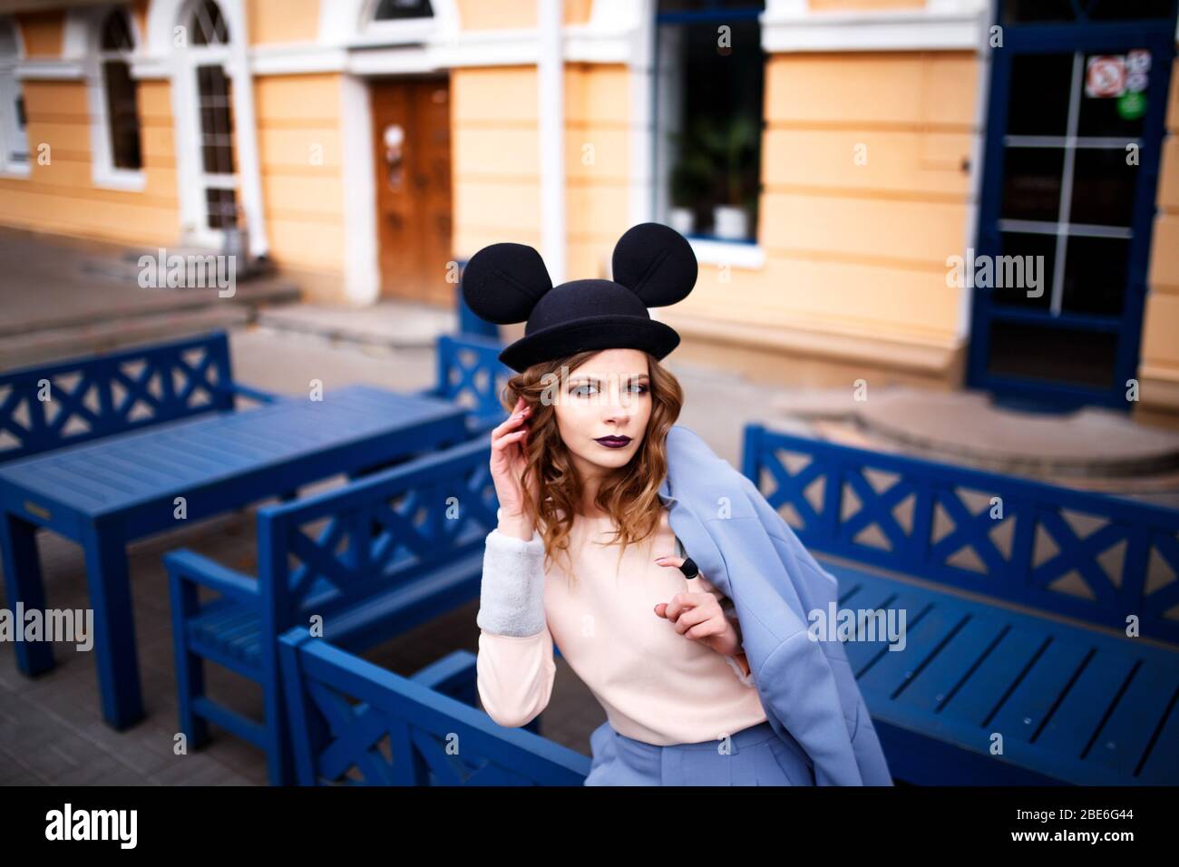 Cute girl on the street in a funny hat. Autumn leave. The Ears Of Mickey  Mouse Stock Photo - Alamy