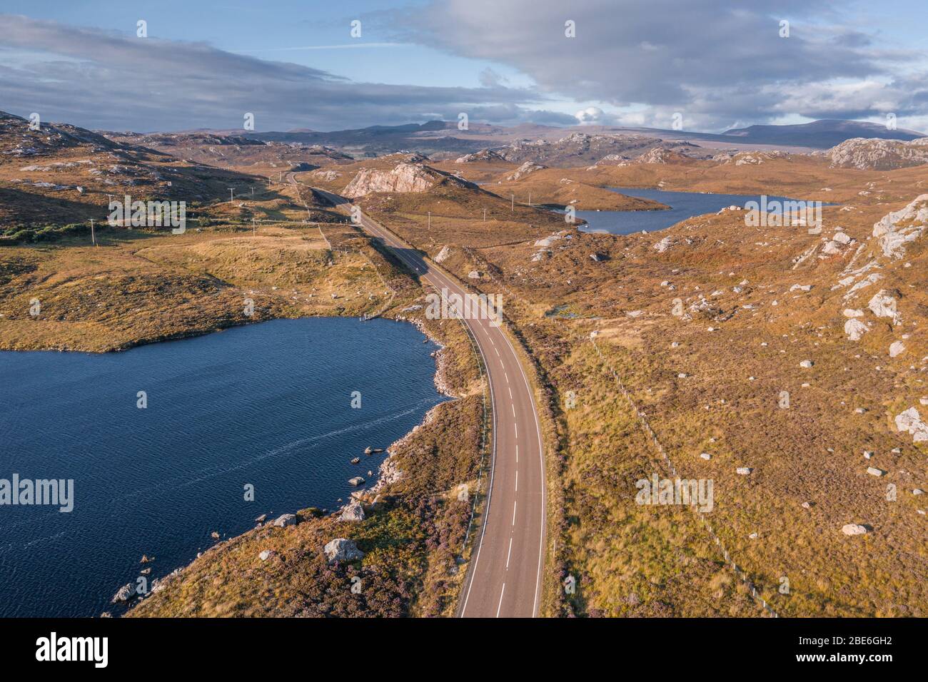 Drone shoot over A838 road at bright autumnal evening in the North West Highlands of Scotland - NC500 Route Stock Photo