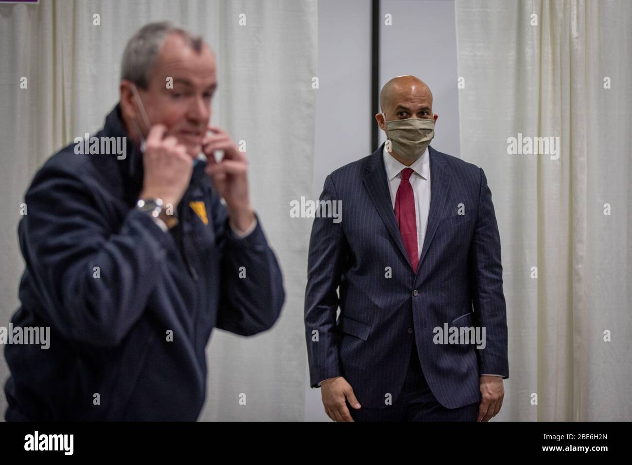 New Jersey Gov. Phil Murphy and Senator Cory Booker, right, takes a tour of a Field Medical Station for treating COVID-19 patients at the New Jersey Convention and Exposition Center April 8, 2020 in Edison, New Jersey. Stock Photo