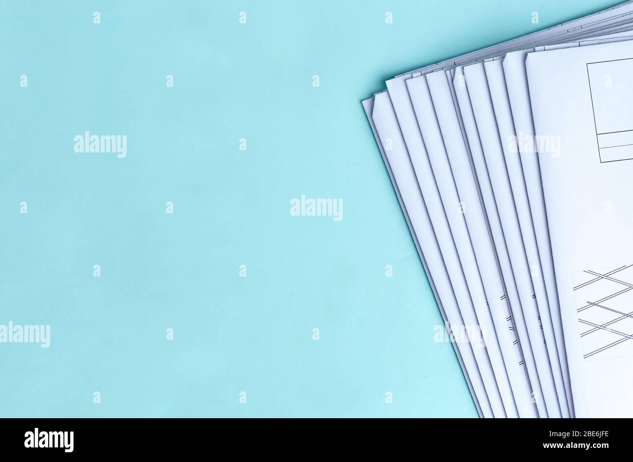 Stack Folding drawings on a blue background. Top view. Flat lay. Stock Photo