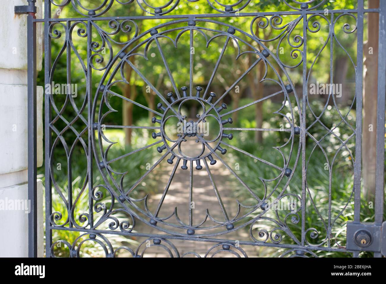 An iron gate leading to a private garden in Charleston, South Carolina Stock Photo