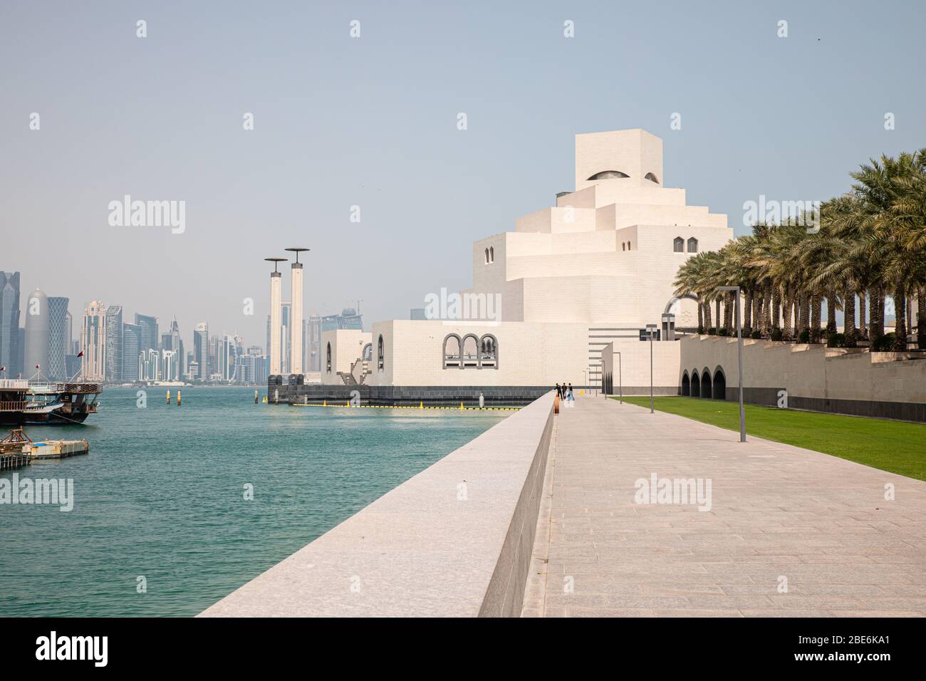 View on white Museum of Islamic Art in Doha City in Qatar with Persian Gulf water background nad raw of palm trees Stock Photo