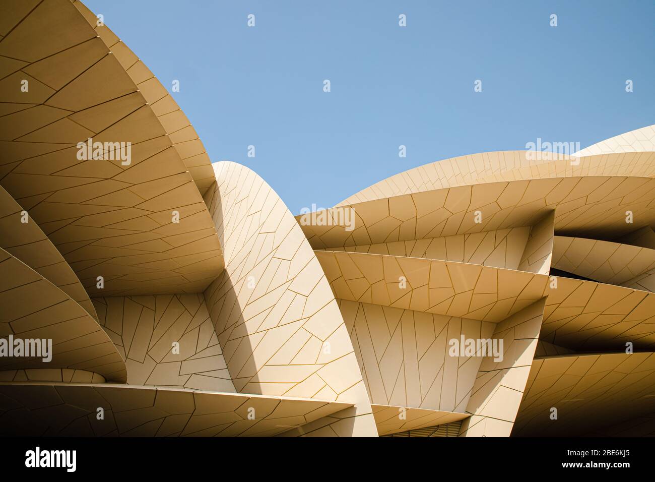 Modern contemporary architecture National Museum of Qatar by Jean Nouvel in Doha city with blue sky backgound Stock Photo