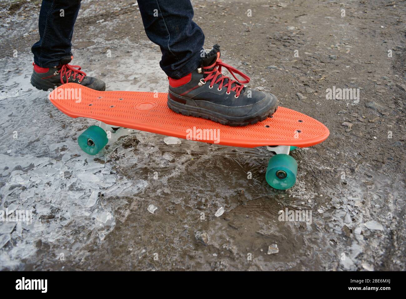Skateboard on a frozen road with a kid Stock Photo - Alamy