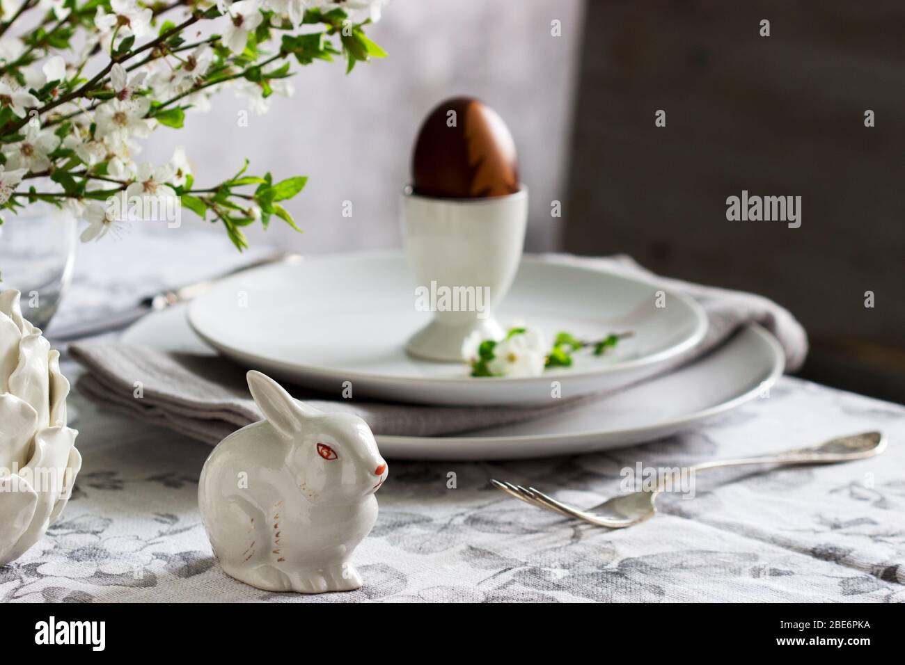 Decorated Easter table with blooming cherry plum. Stock Photo