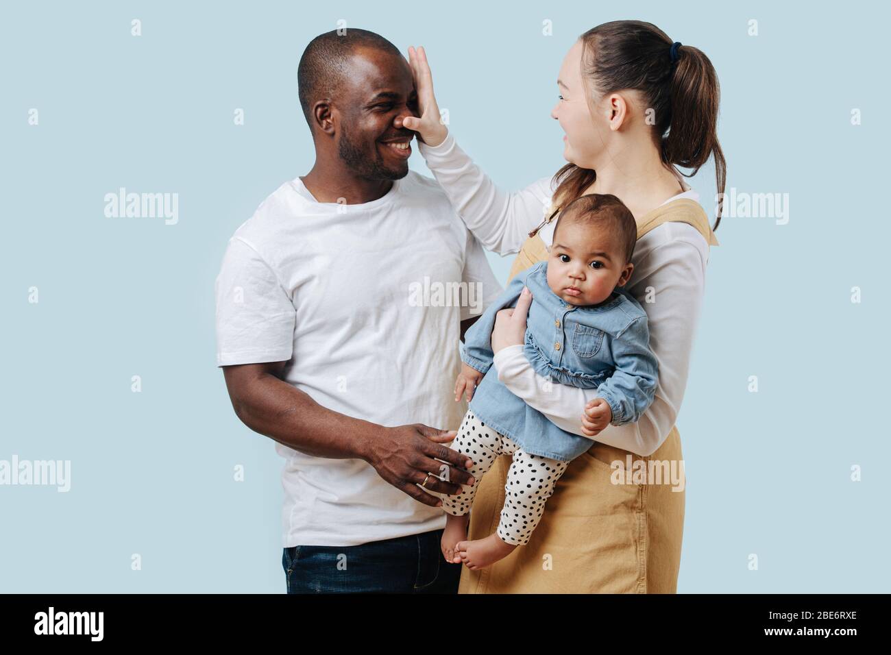 Happy mixed race family interacting with each other, doing silly things Stock Photo
