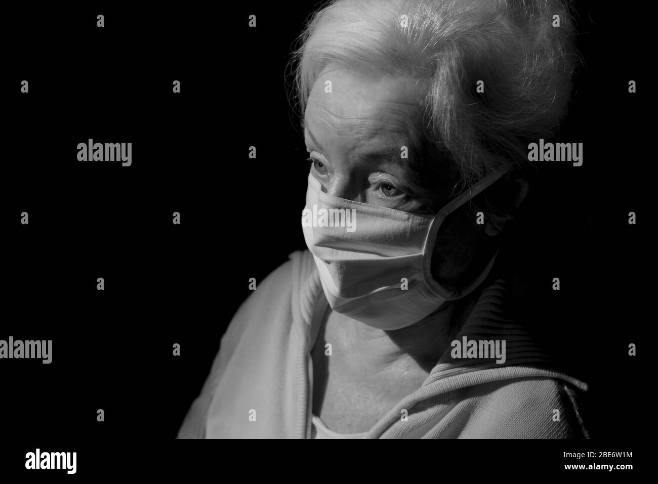 Black and white portrait of senior woman wearing face mask Stock Photo