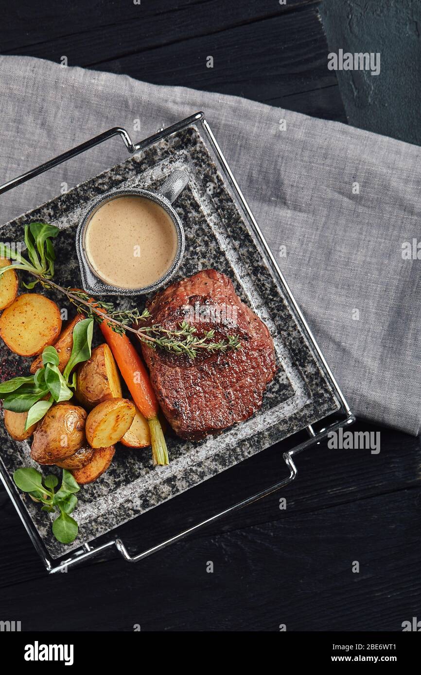 Grilled ribeye steak on stone grill on a dark background Stock Photo - Alamy