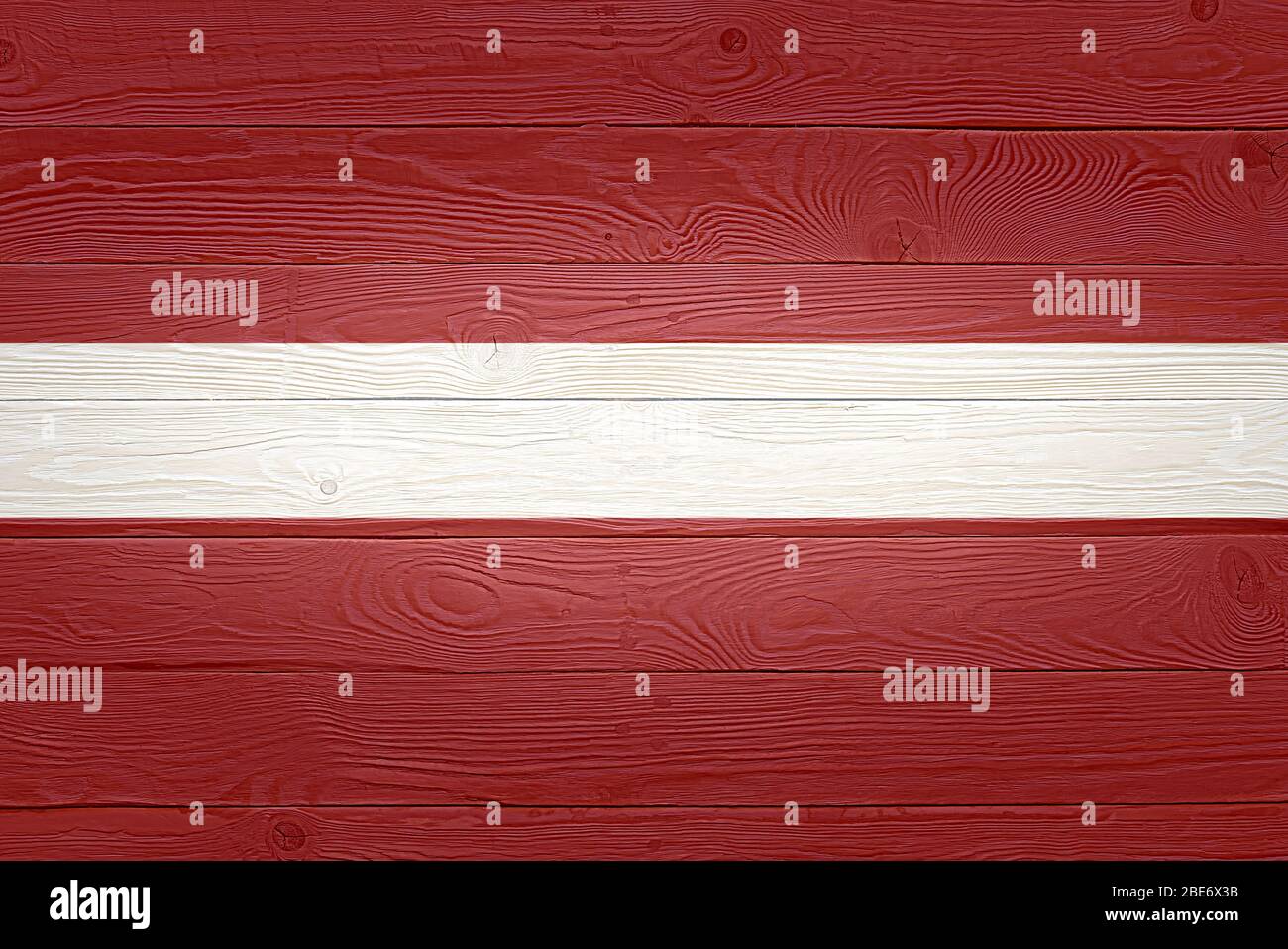 Latvia flag painted on old wood plank background. Brushed natural light ...