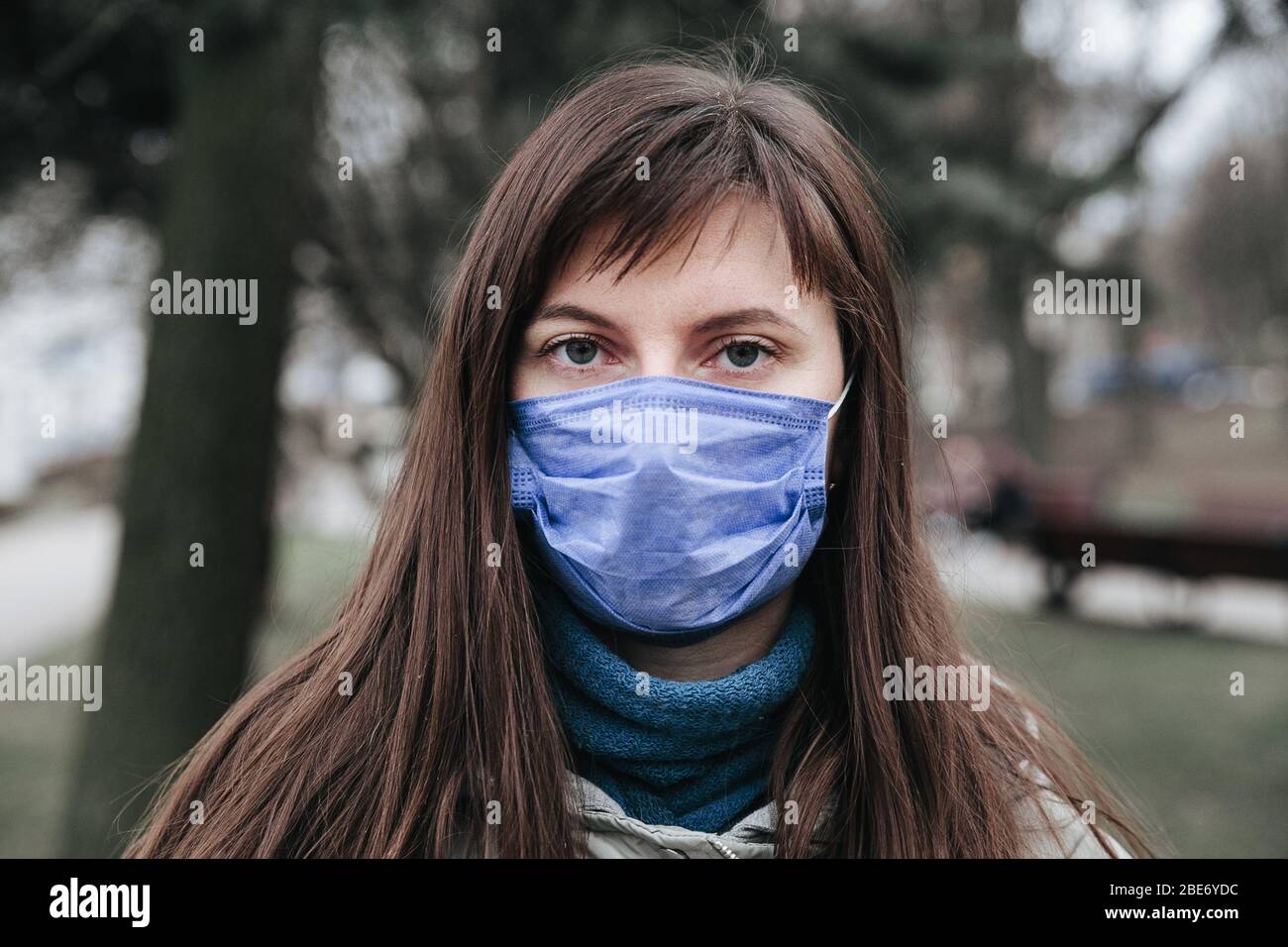 portrait of brunette woman in a surgical bandage .Coronavirus epidemic, illness, infection, quarantine, medical mask Stock Photo