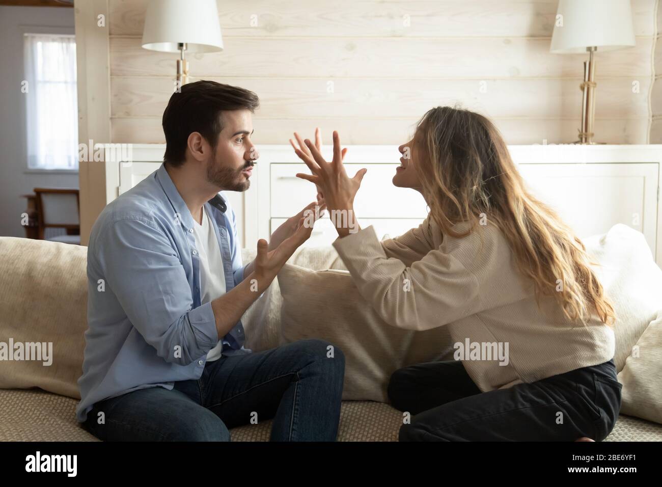 Emotional annoyed stressed couple arguing at home Stock Photo - Alamy