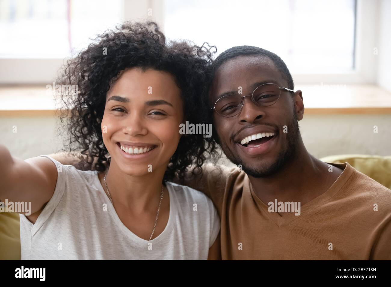 Close up headshot portrait of African American couple taking selfie. Stock Photo