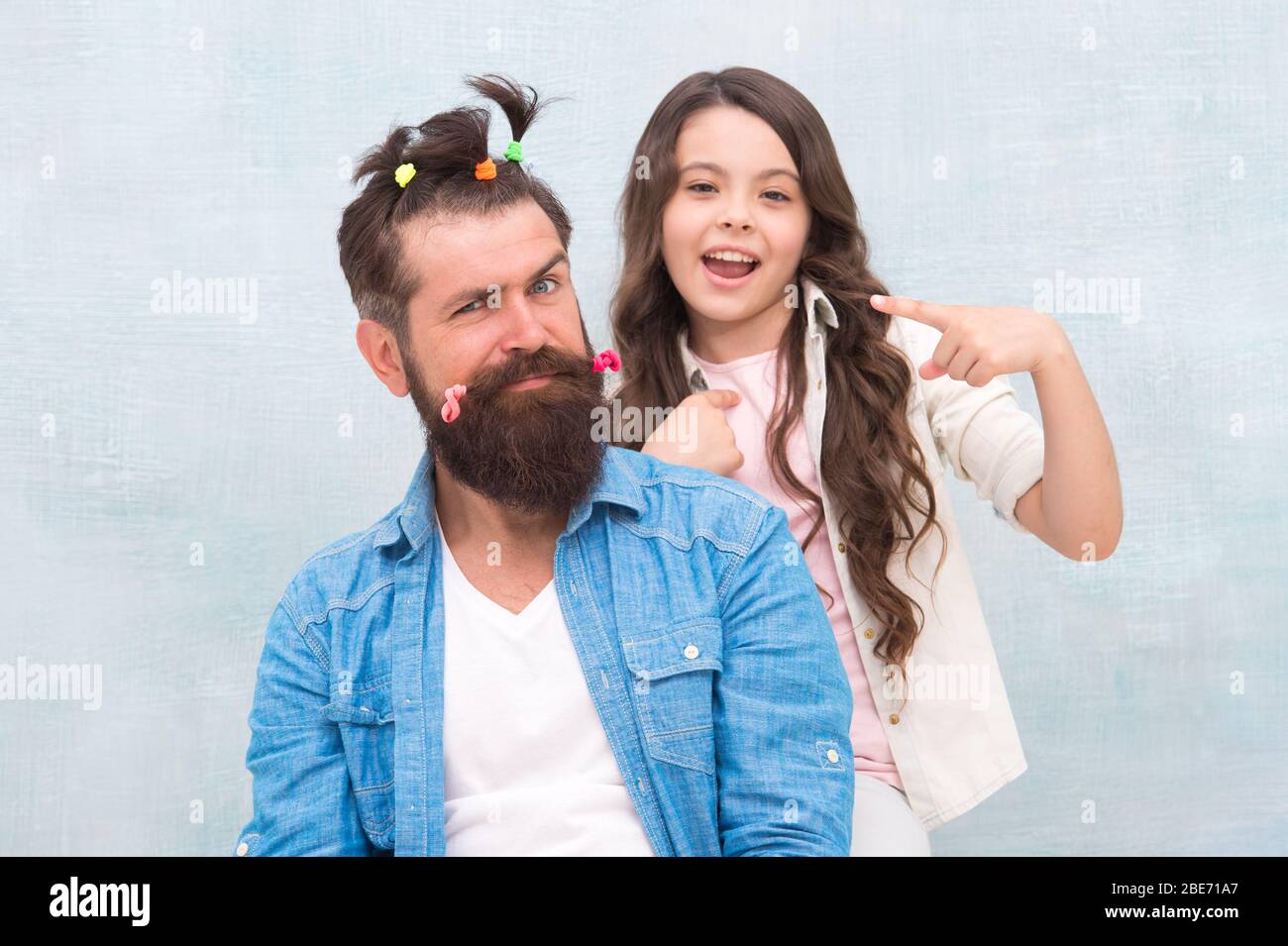 Looking good. hairdresser and barbershop. happy family day. small girl play  with dad. bearded man father having fun with kid. childrens day. love and  trust. daughter and father with funny hairdo Stock
