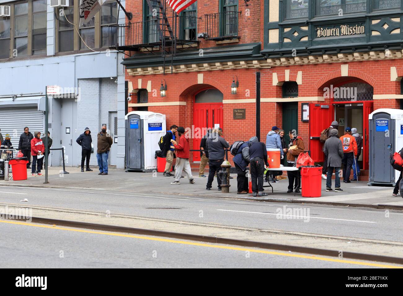 People social distancing as they queue for Easter lunch at the Bowery