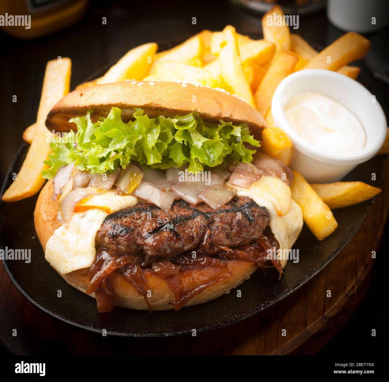 Large, abundant and tasty Hamburger with french fries Stock Photo