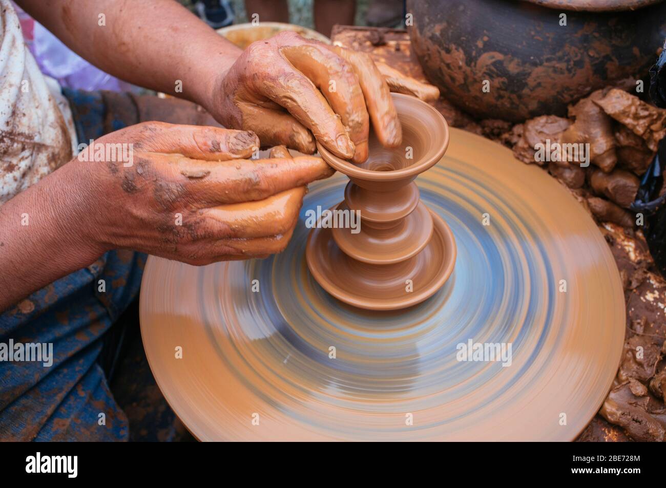 artisan potter molding a piece of clay on a lathe Stock Photo