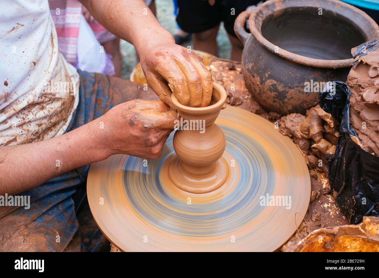 artisan potter molding a piece of clay on a lathe Stock Photo