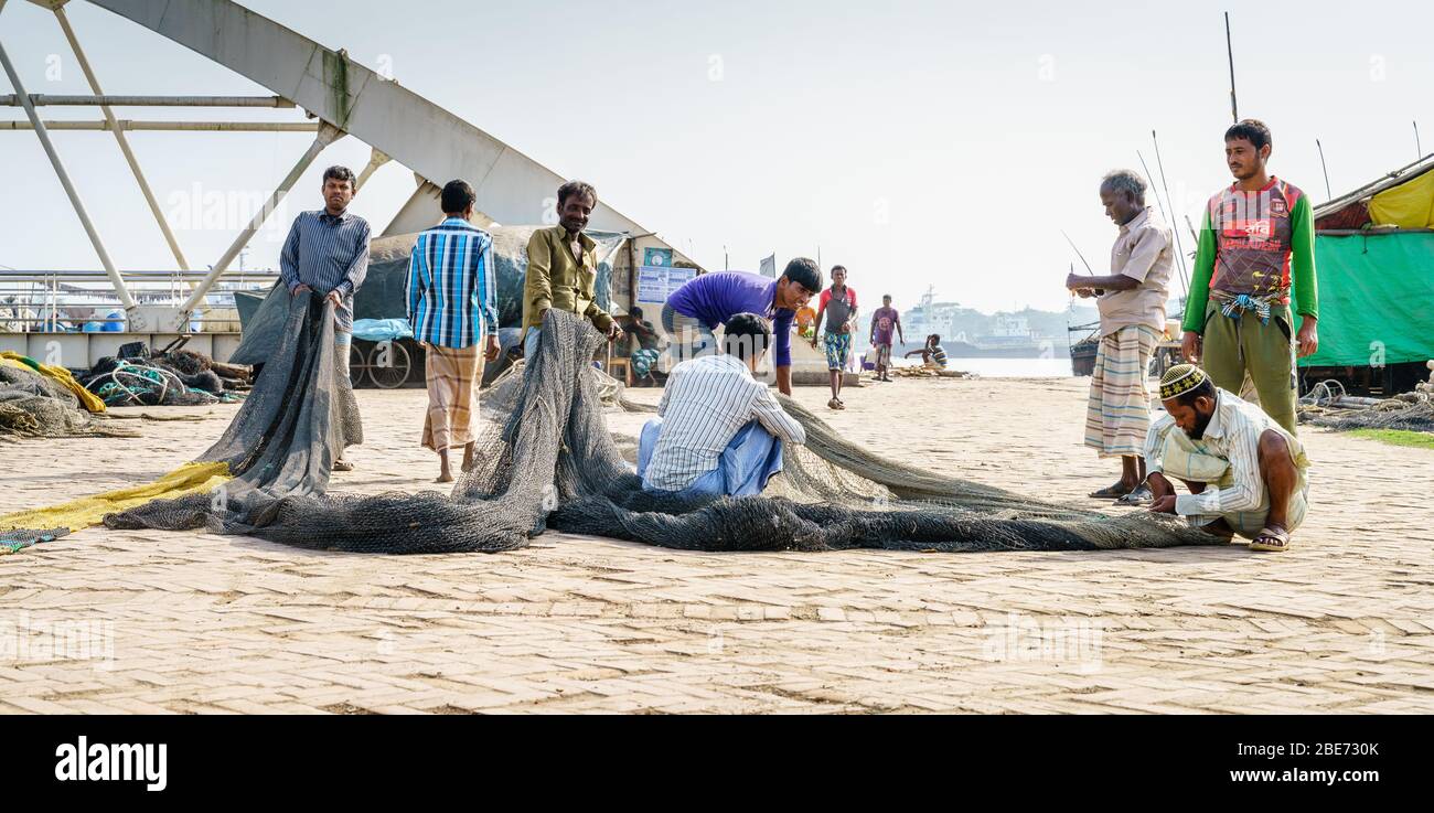 Chittagong, Bangladesh, December 22, 2017: Fishermen working with the nets in a park near the Karnaphuli River in Chittagong, Bangladesh Stock Photo