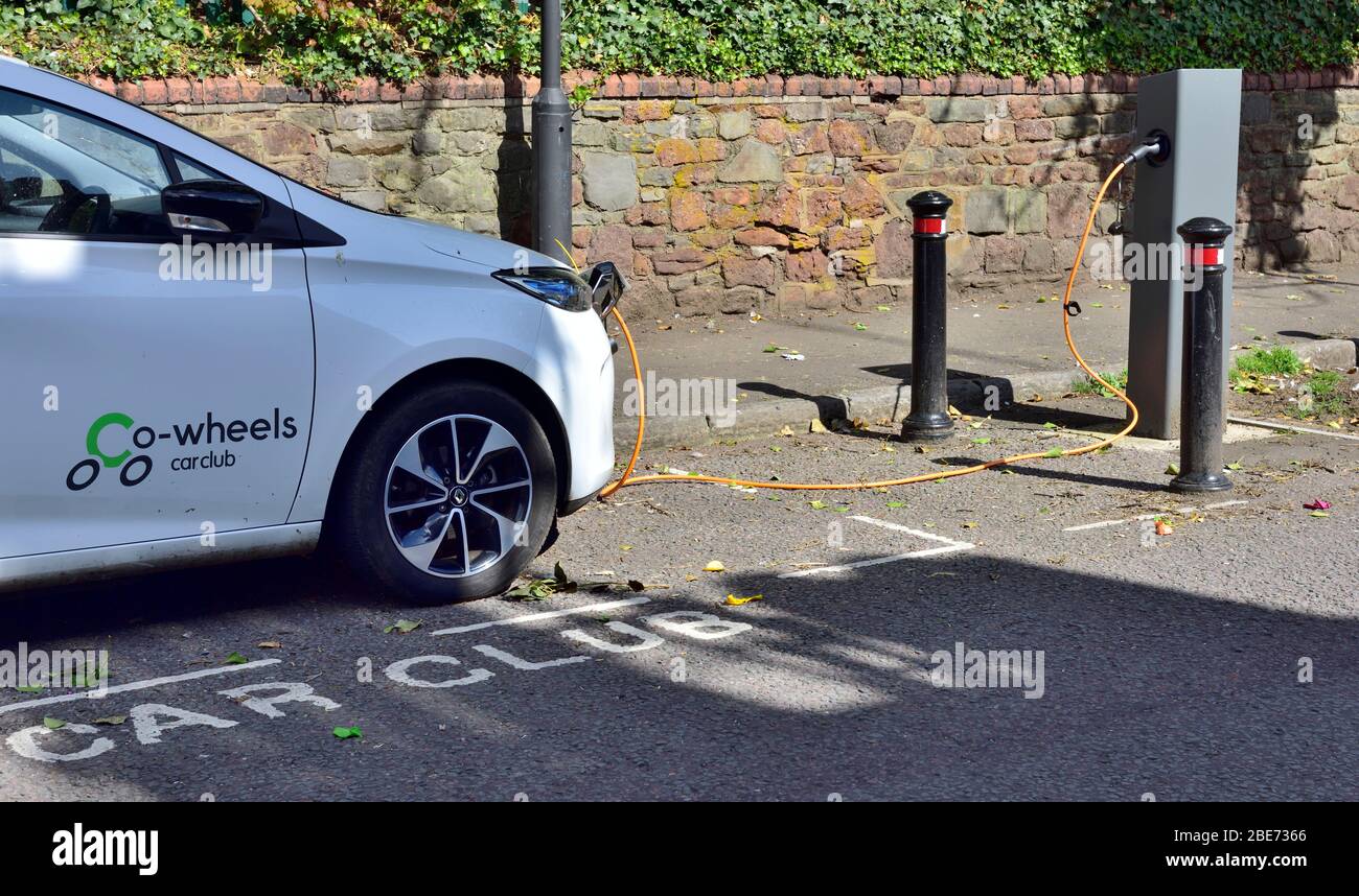 Electric car club car parked in designated space charging on a public