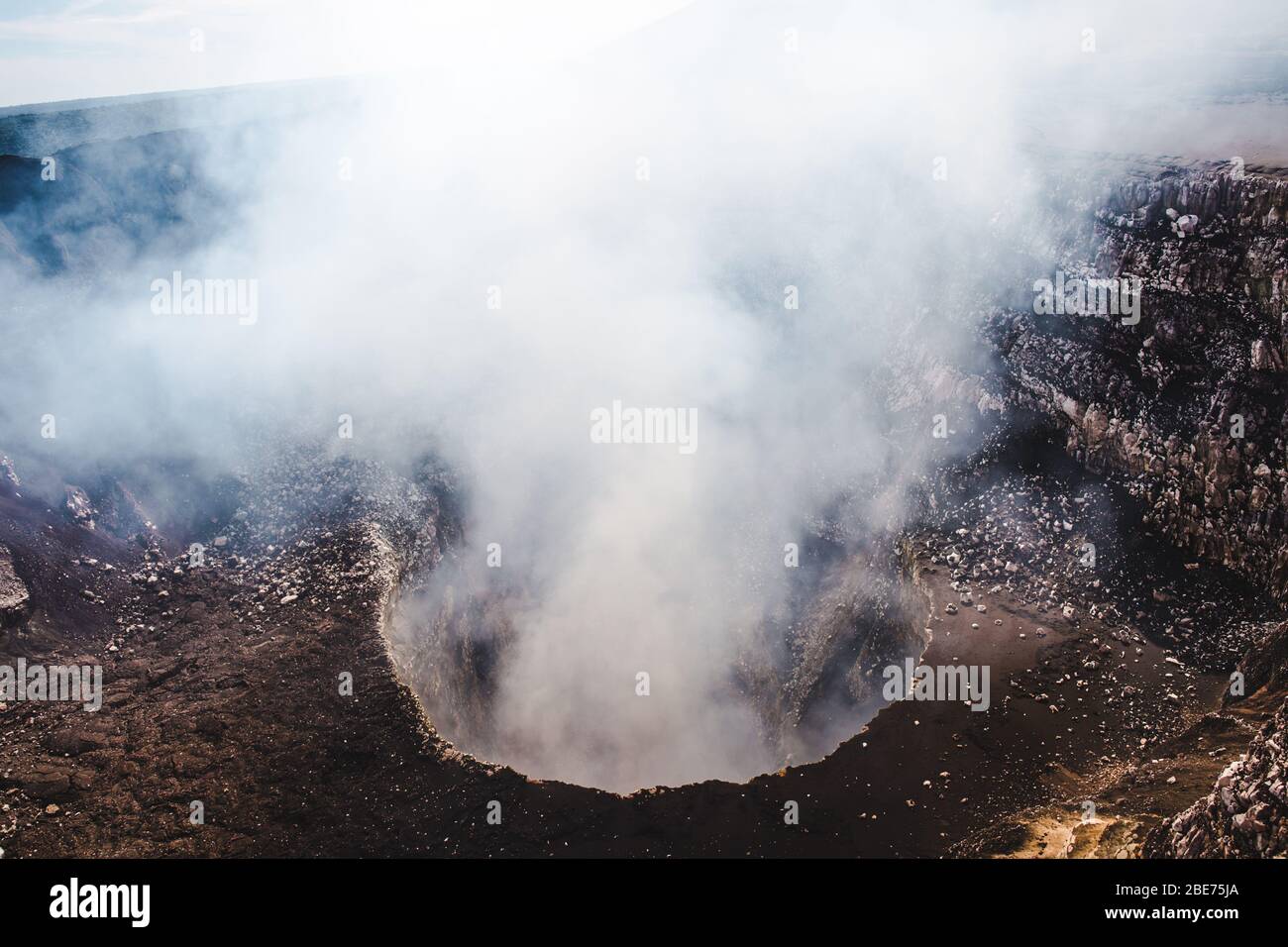 Looking down into the steaming crater of Volcan Masaya, an active volcano filled with molten lava near Granada, Nicaragua Stock Photo