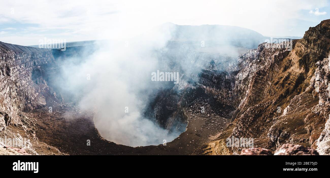 Looking down into the steaming crater of Volcan Masaya, an active volcano filled with molten lava near Granada, Nicaragua Stock Photo
