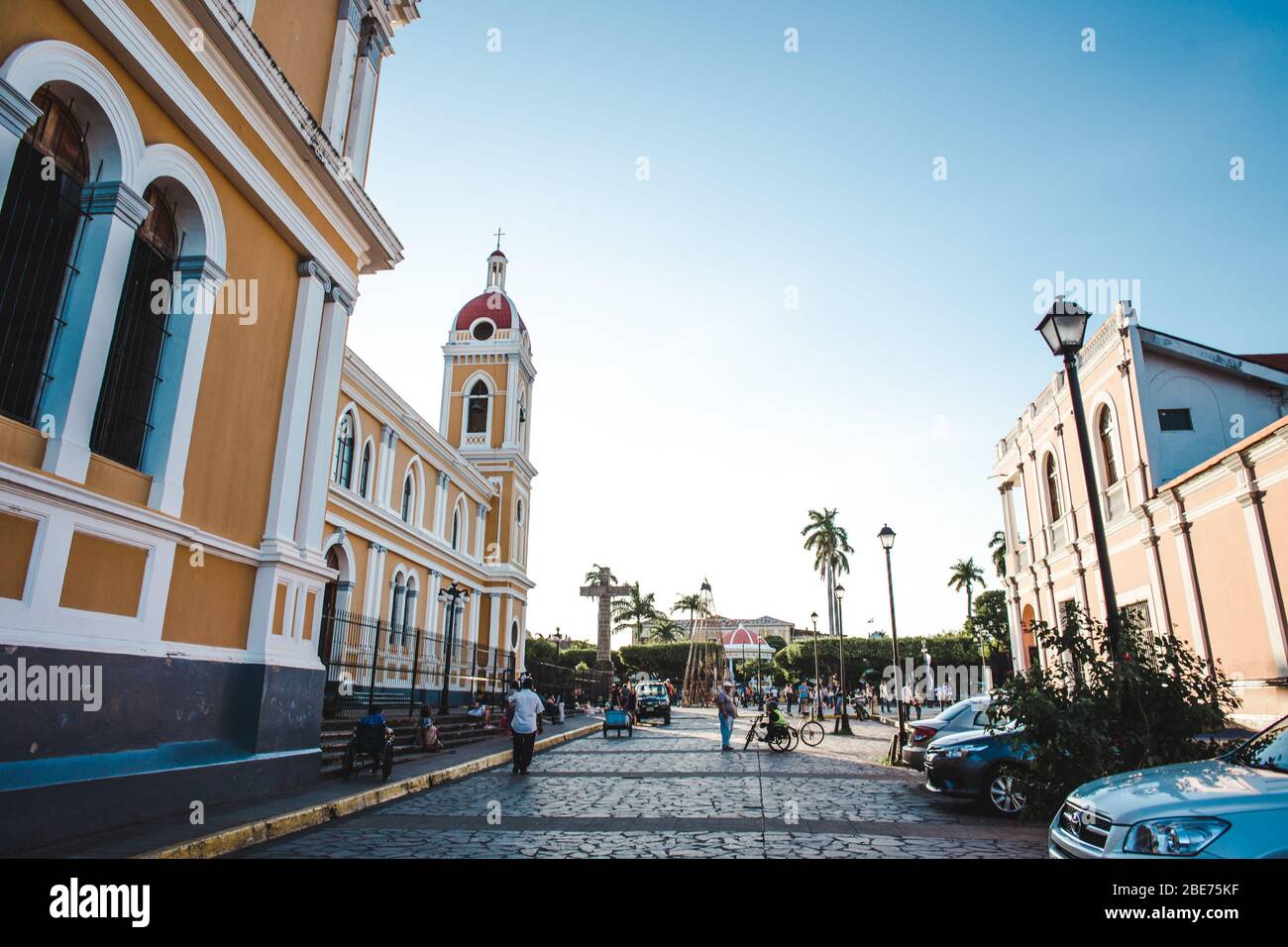 The western end of Calle La Libertad, the main tourism strip of Granada, Nicaragua, as it leads to the yellow cathedral & main plaza (Parque Central) Stock Photo