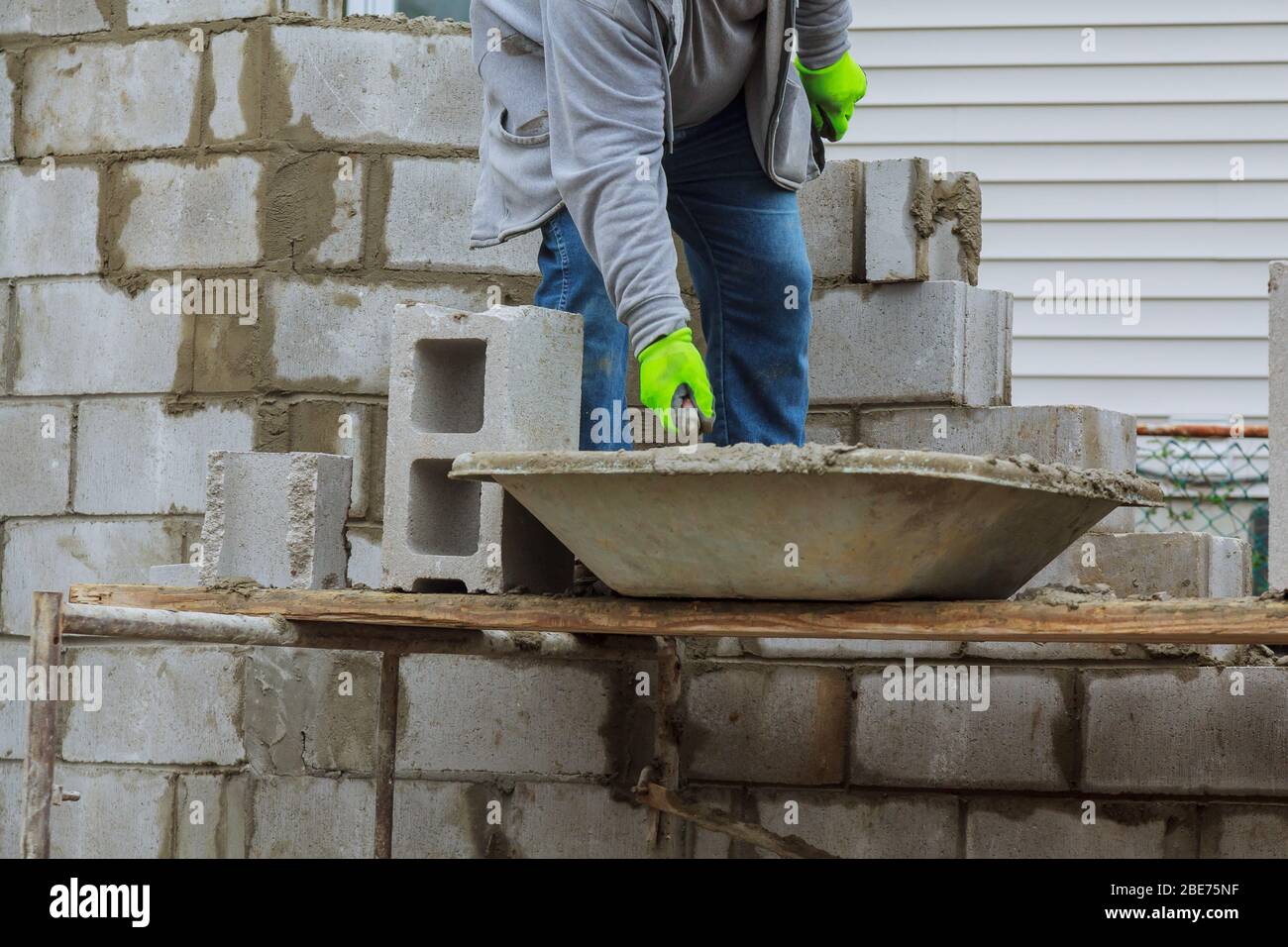 Bricklayers new house wall on foundation hands with in masonry ...