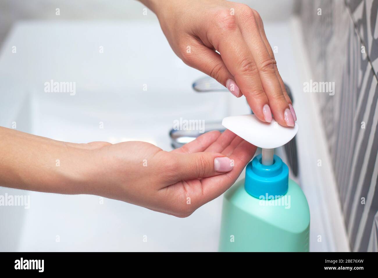 Hand washing. A woman uses soap to wash her hands. hygiene concept