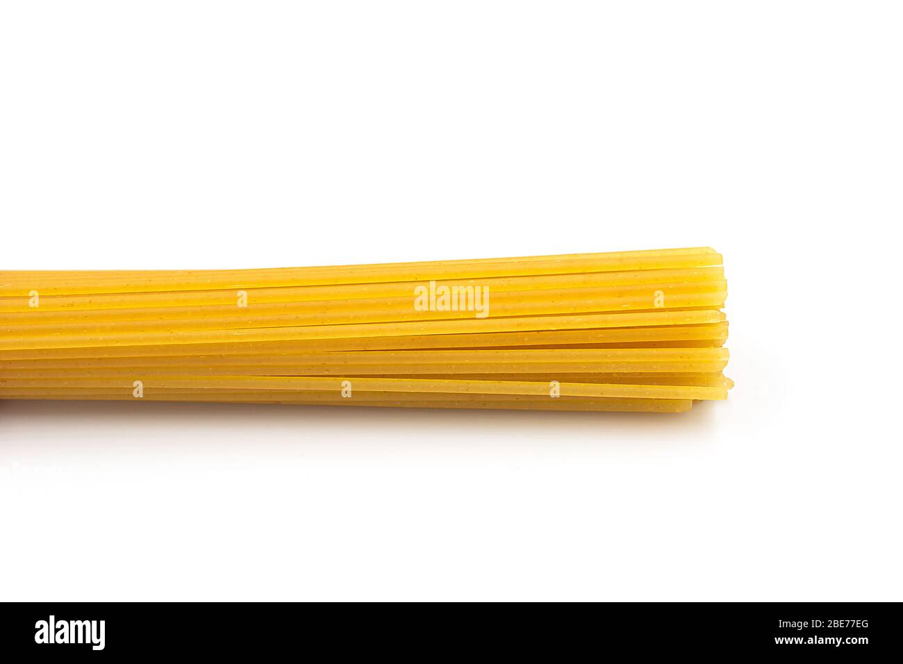 Homemade spaghetti pasta heap on white isolated background in macro top