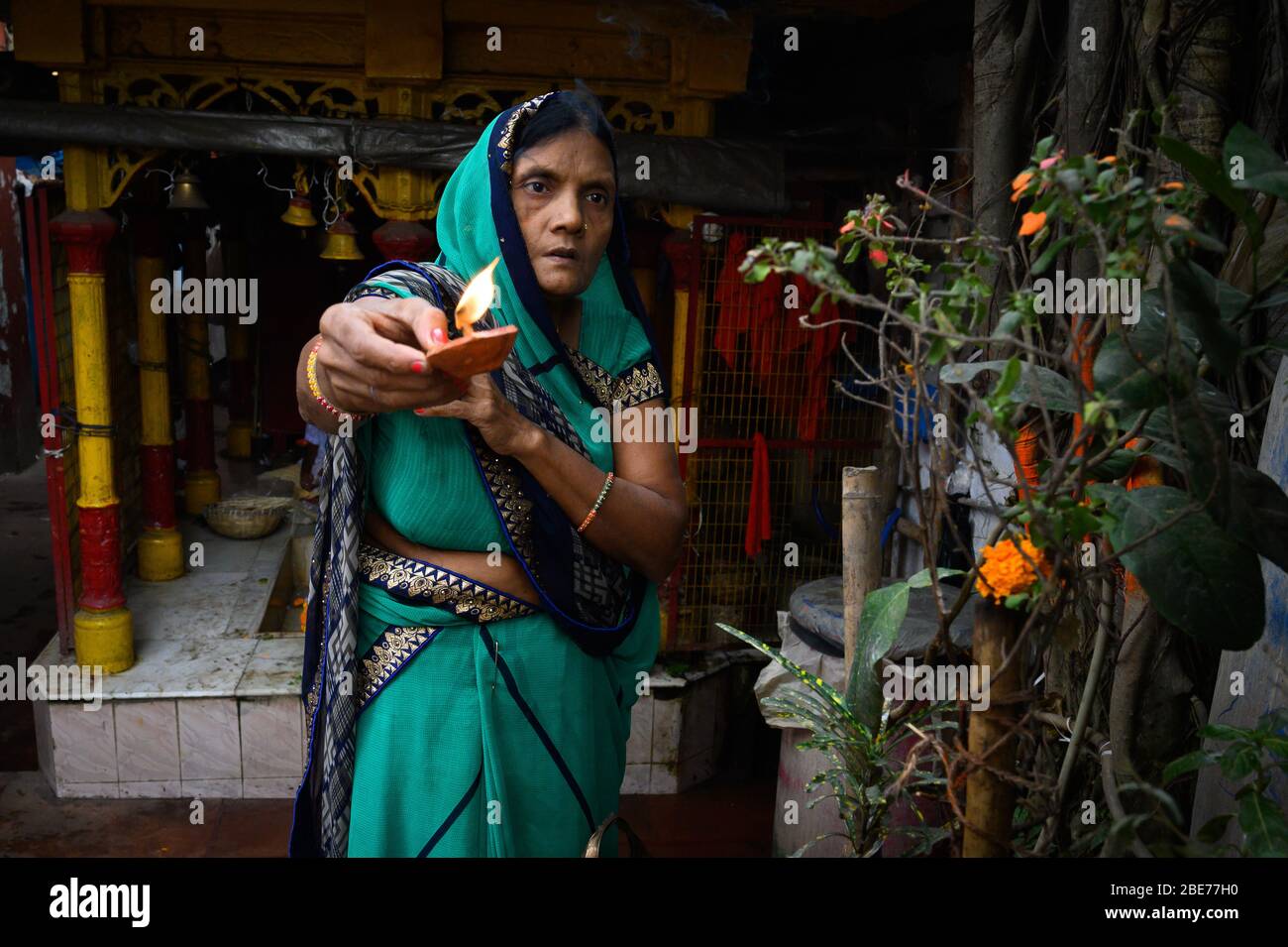 Worshipping woman, Mullicj Ghat, Kolkata, India Stock Photo