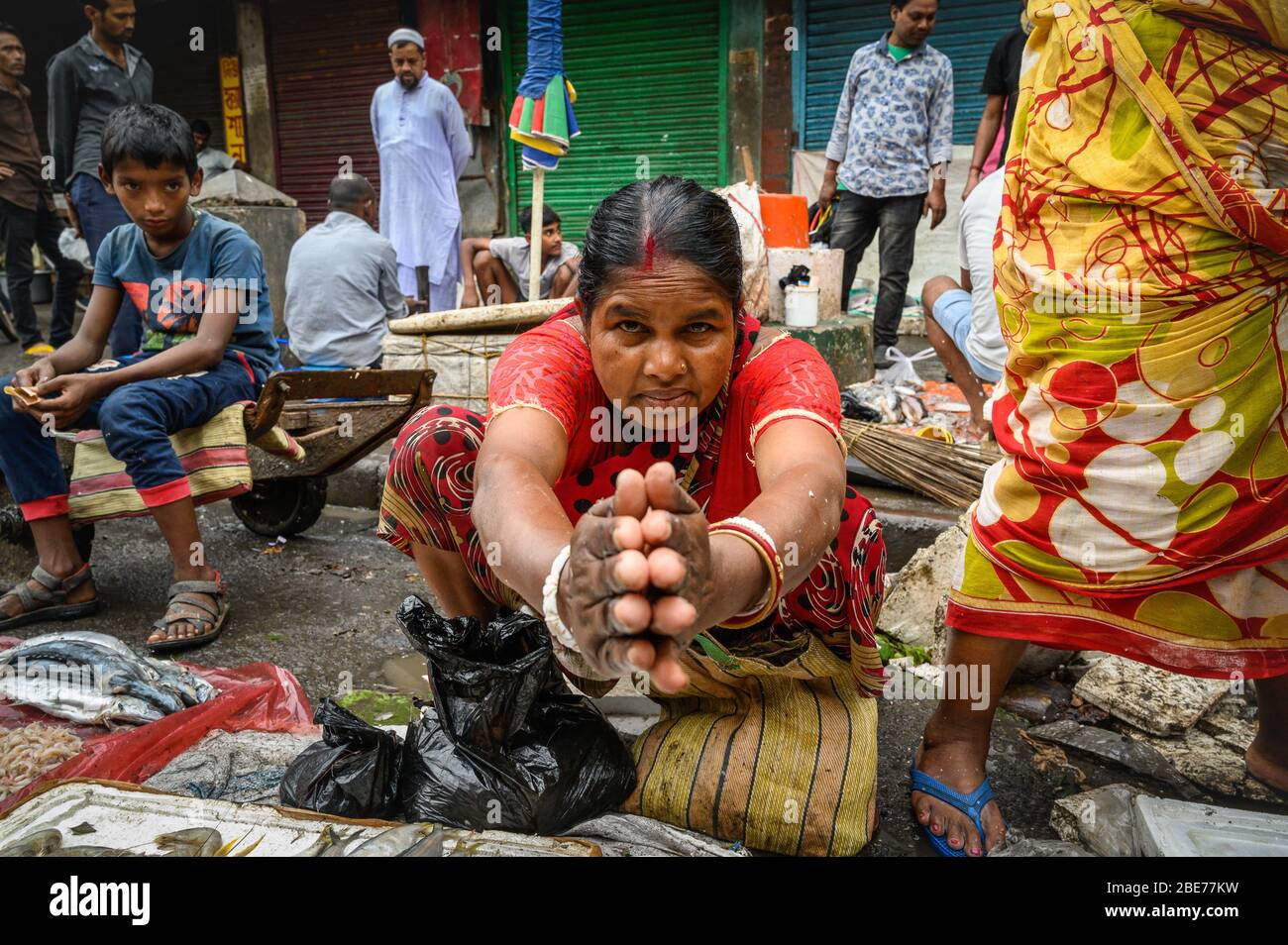 Female street vendor welcoming business, Kalkota, India Stock Photo
