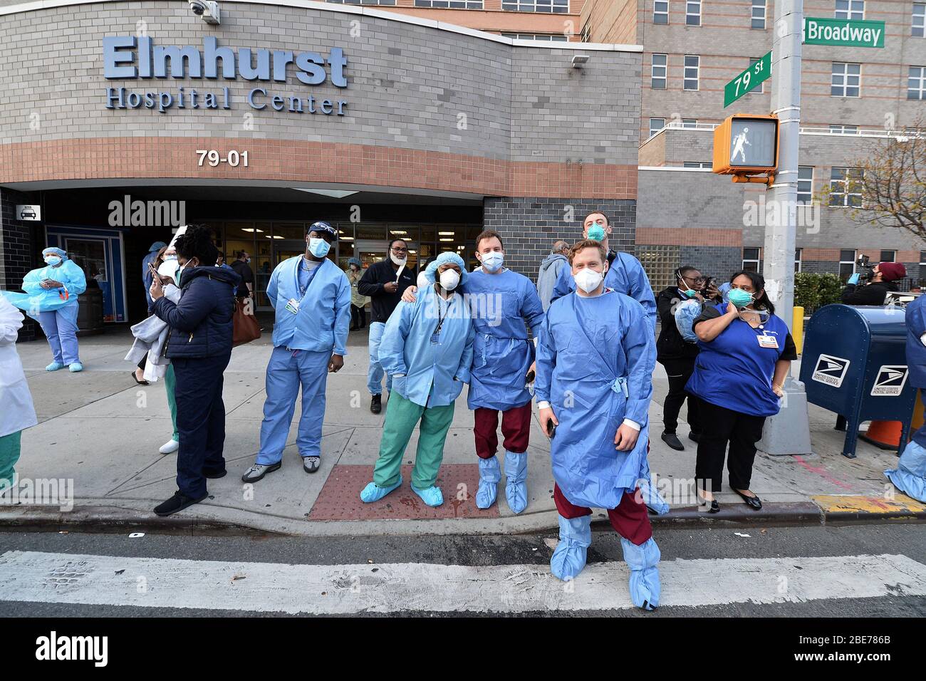 New York City, USA. 12th Apr, 2020. Medical staff and essential healthcare workers watch as members of the New York City Fire Department join together outside Elmhurst Hospital to show their gratitude to those workers on the front lines of the coronavirus pandemic, in the New York City borough of Queens, NY, on April 12, 2020. (Anthony Behar/Sipa USA) Credit: Sipa USA/Alamy Live News Stock Photo