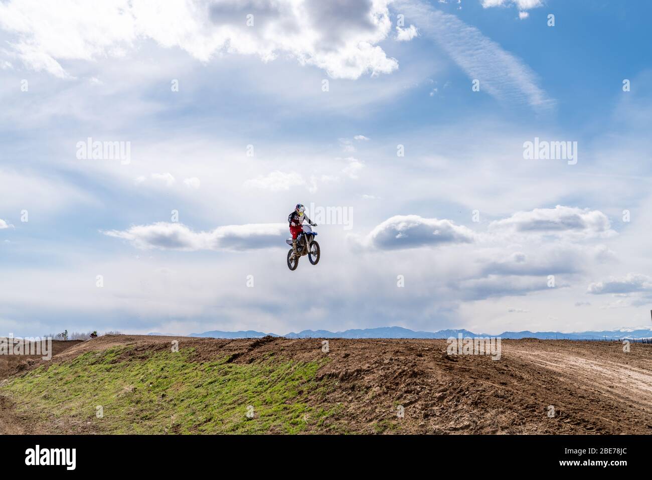 Dacono, CO/ USA- March29, 2020 Motocross riders race around the track hitting jumps and berms in Colorado's Front Range Stock Photo