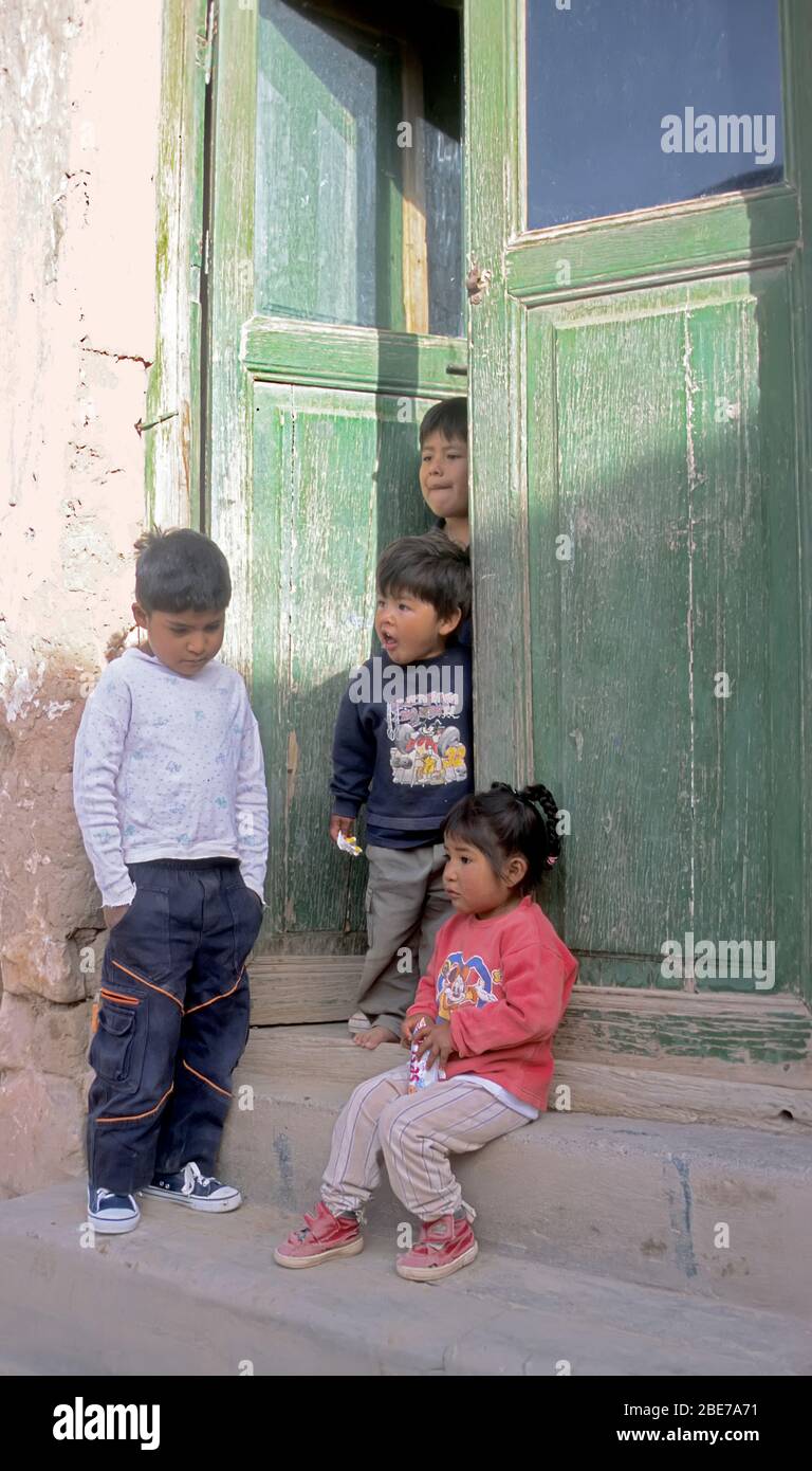 Children in doorway Purmamarca, Jujuy, Argentina Stock Photo