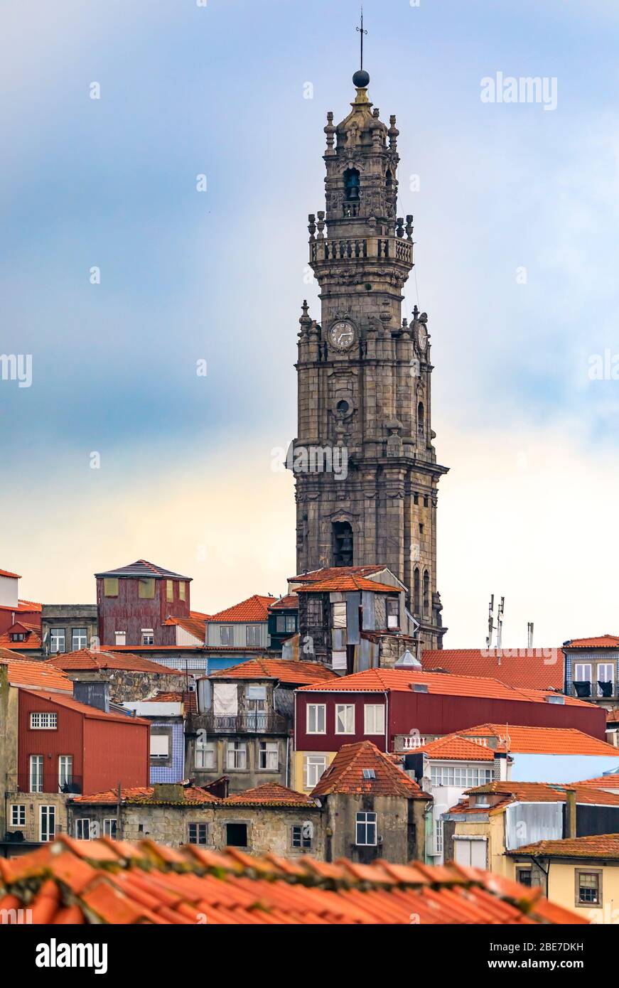 Cityscape with baroque Torre dos Clerigos church bell tower over the terracotta roofs of the old town, one of characteristic symbols of Porto Portugal Stock Photo