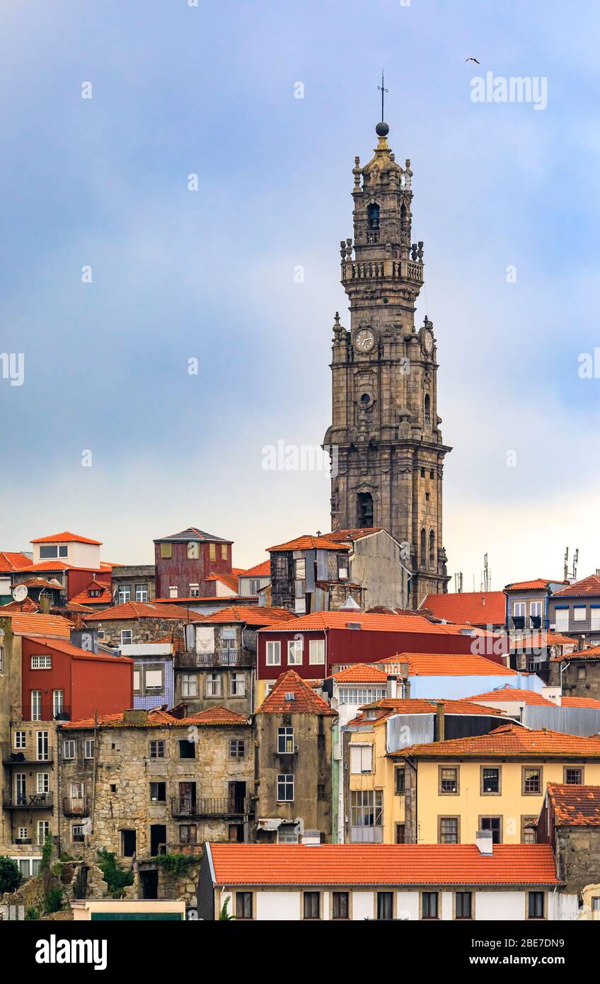 Cityscape with baroque Torre dos Clerigos church bell tower over the terracotta roofs of the old town, one of characteristic symbols of Porto Portugal Stock Photo