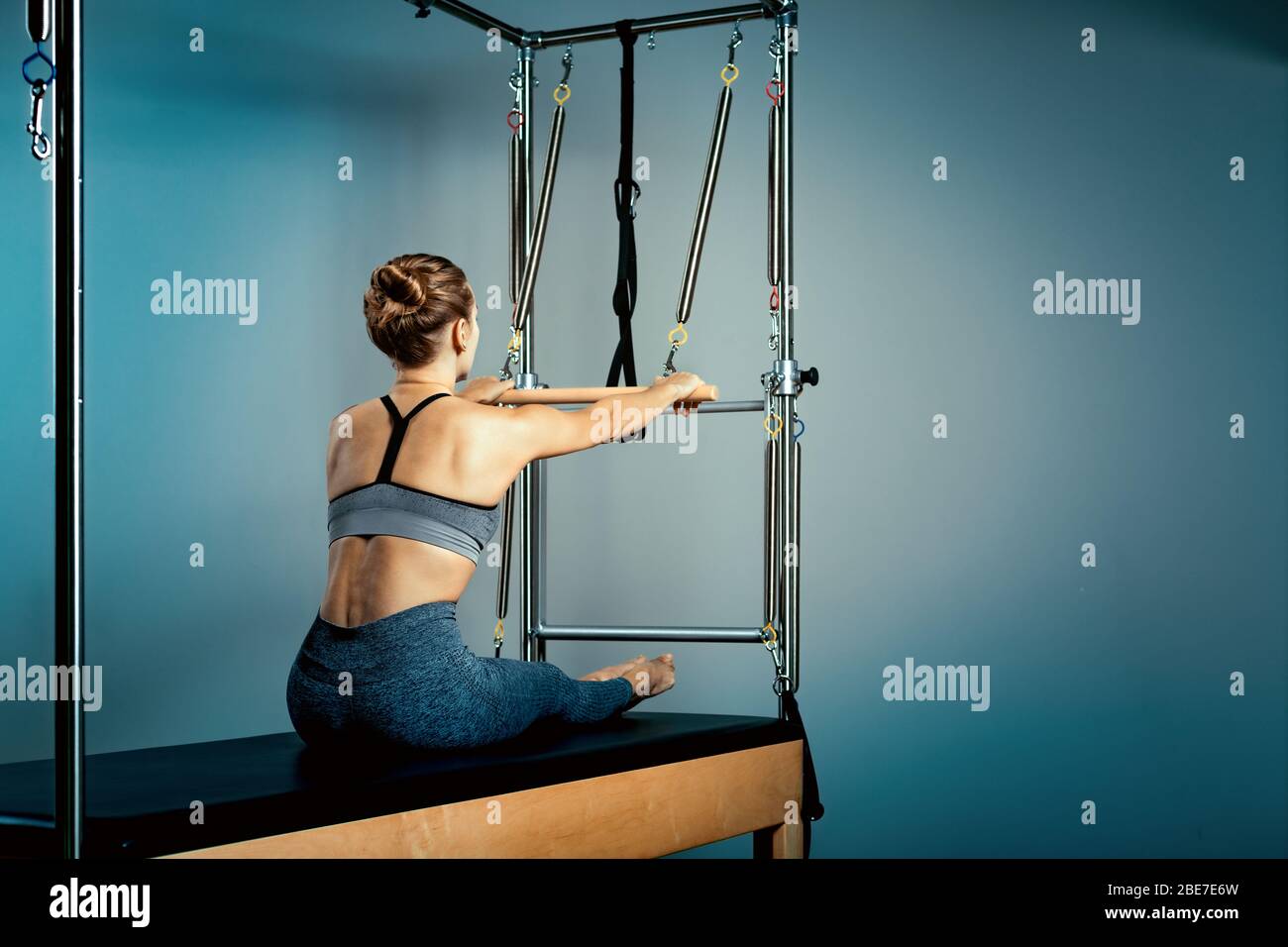 Gymnast woman pilates stretching sport in reformer bed instructor girl
