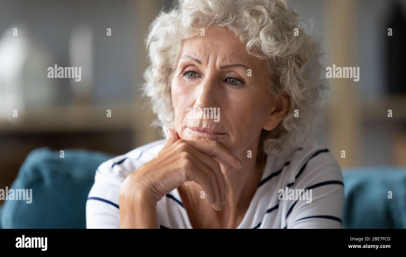 Close up thoughtful mature woman worried about problems Stock Photo