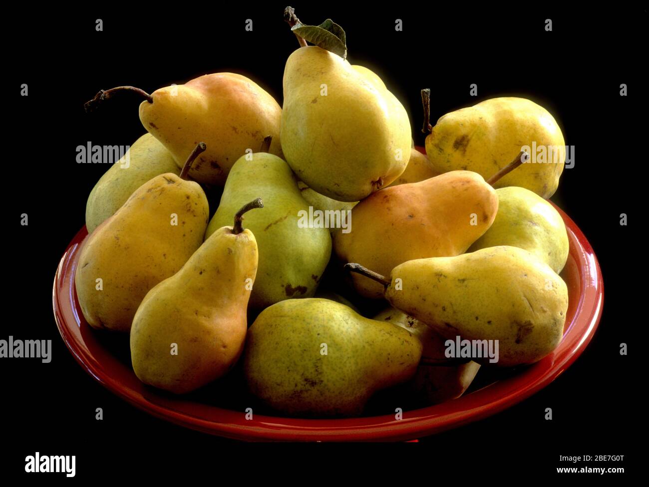 Bartlett pears in a red bowl stilllife Stock Photo Alamy