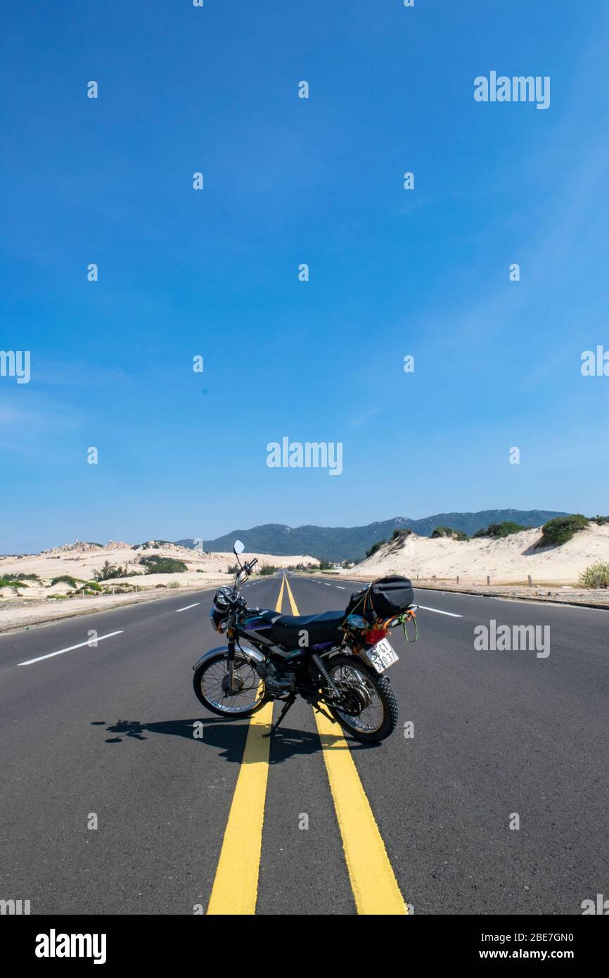 Empty Coastal Road Surrounded By Sand Stock Photo - Alamy