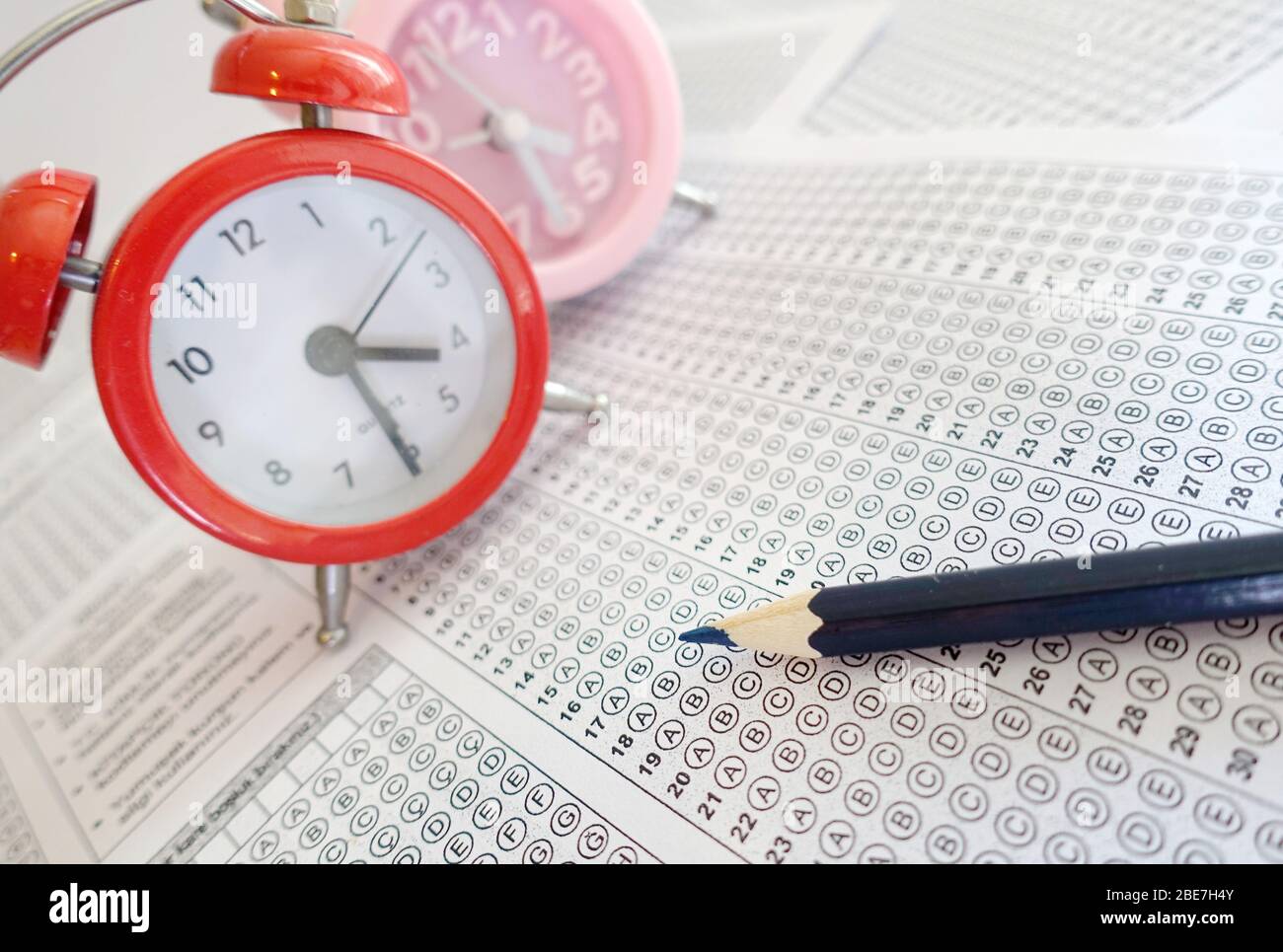 Pencil and clock on answer sheet test exam Stock Photo Alamy