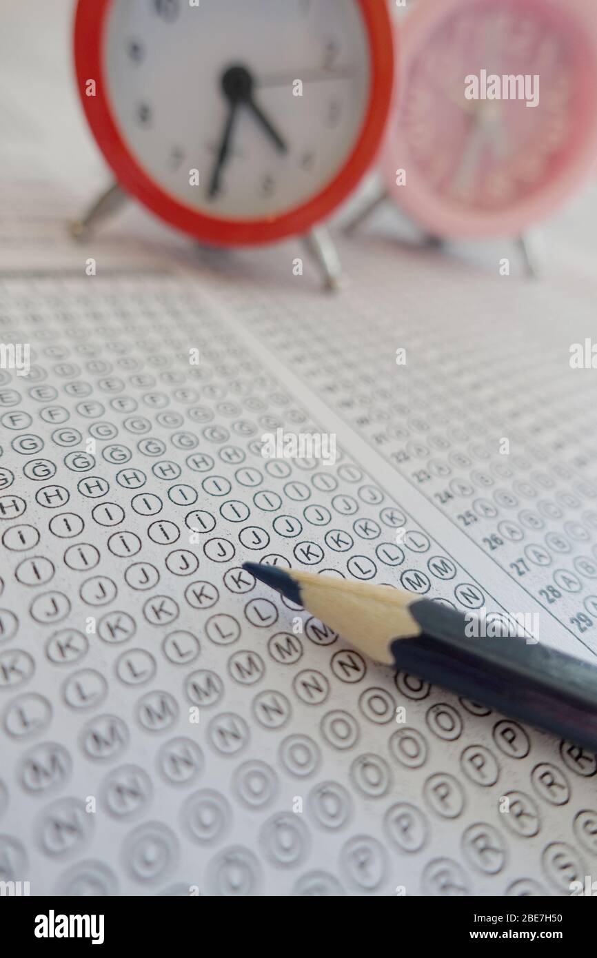 Pencil and clock on answer sheet test exam Stock Photo Alamy