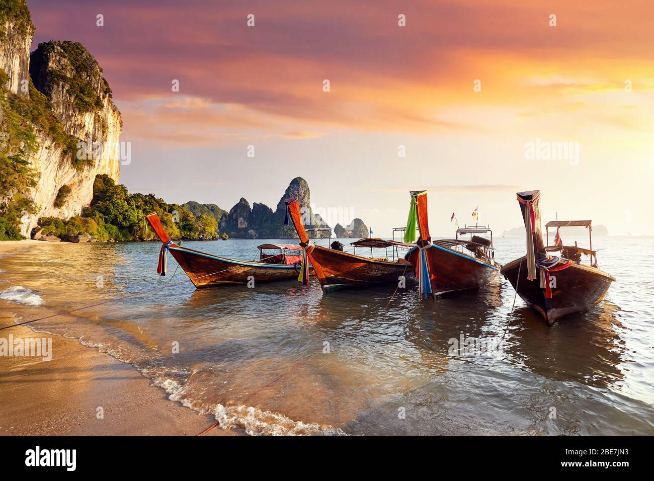 Long tail boats on tropical Tonsai beach at beautiful sunset in Krabi, Thailand Stock Photo
