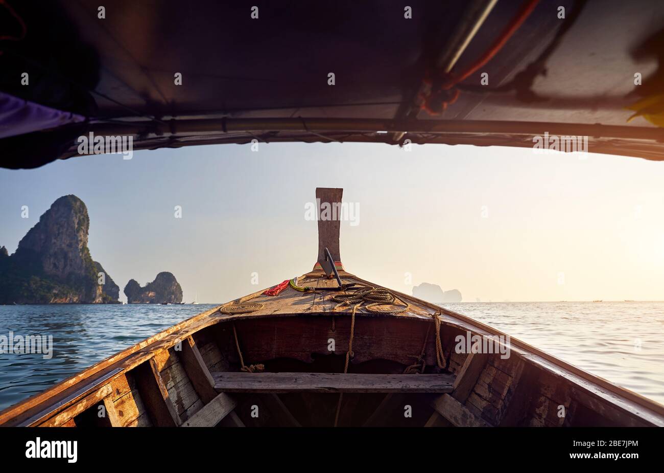 Cruise at long tail boat with view to tropical islands at sunset in Andaman Sea, Thailand Stock Photo