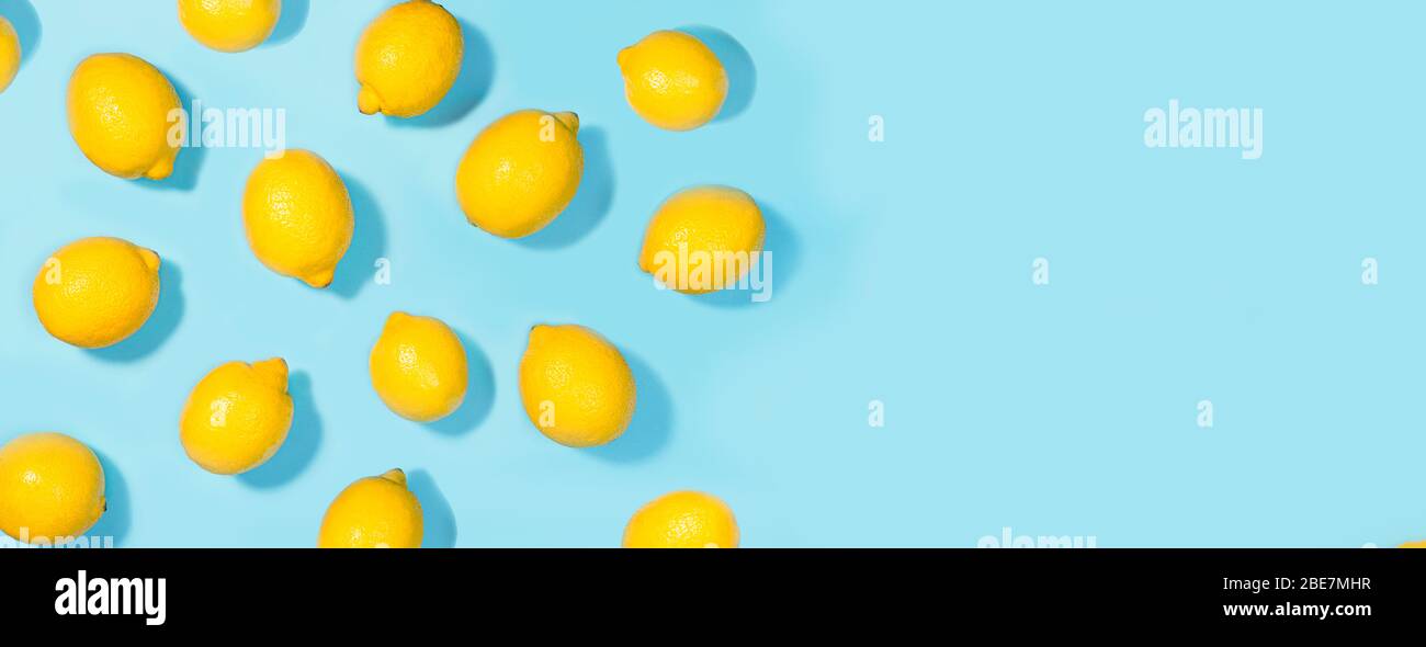 Creative layout made of lemon on green mint color background. Flat lay. Food summer concept. Stock Photo