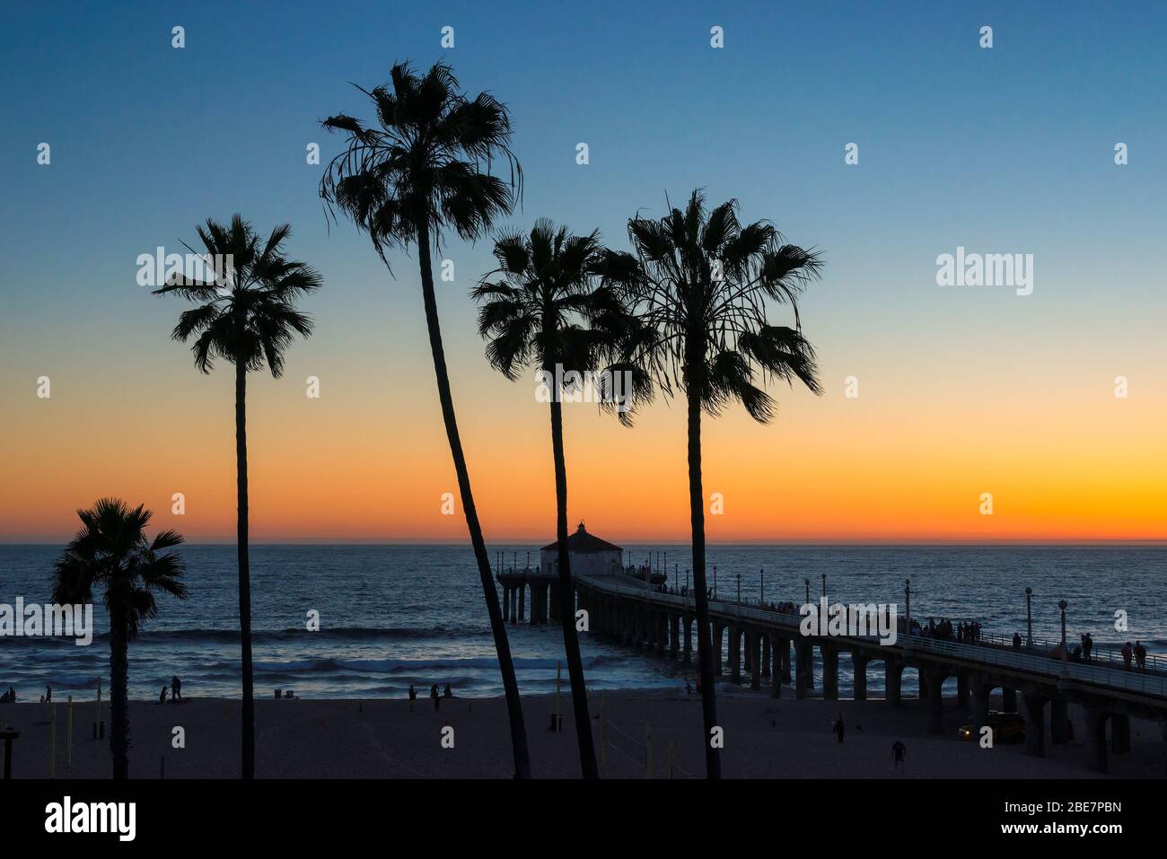 Palm trees over the tropical beach at sunset, California Stock Photo