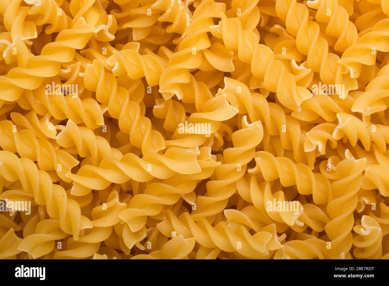 Lots of uncooked fusilli pasta Stock Photo