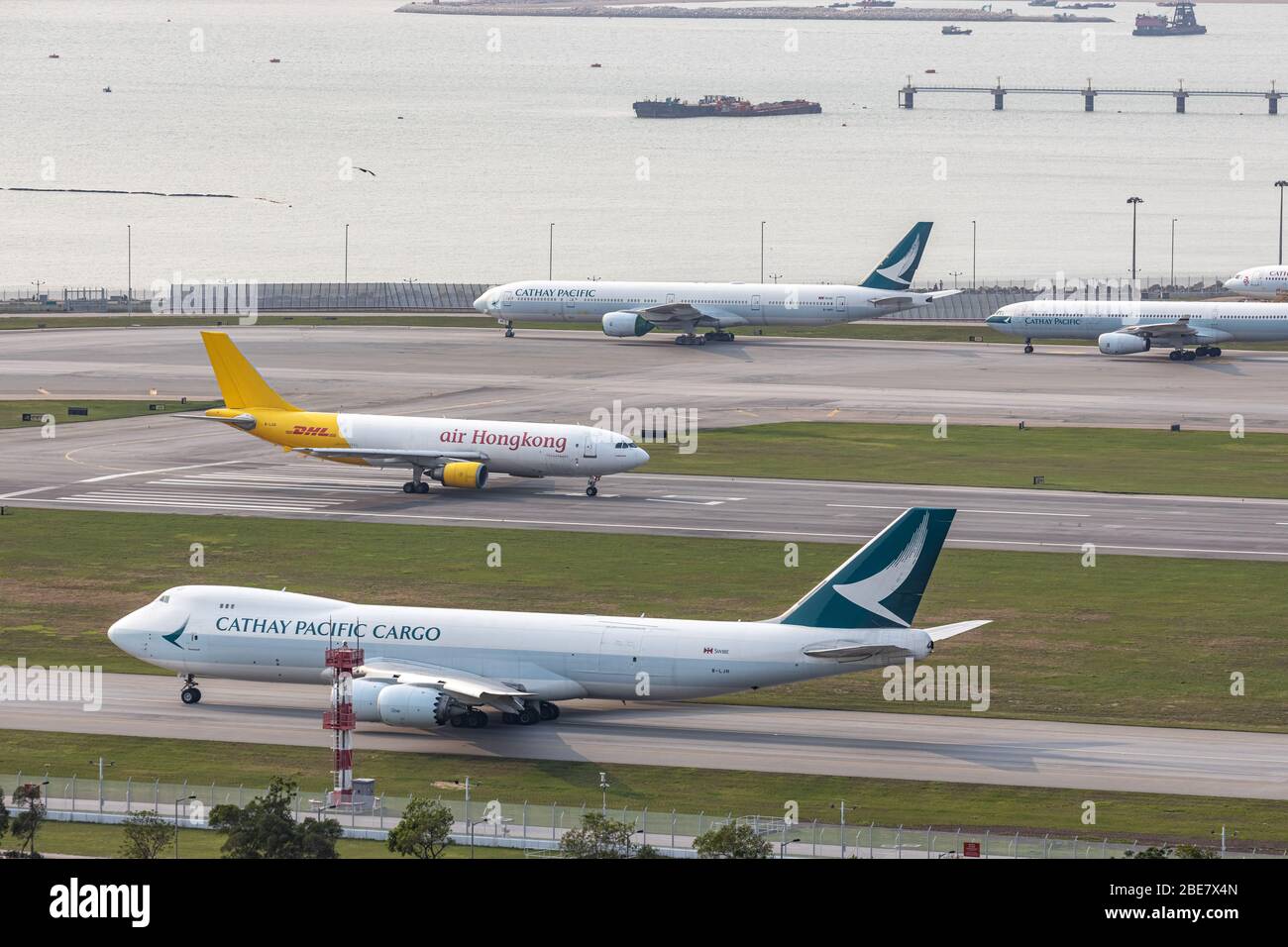 Lantau, Hong Kong  - April 10, 2020 :  Air Hong Kong's cargo airplane is preparing for take off at runway, Cathay Pacific's cargo airplane is queuing Stock Photo