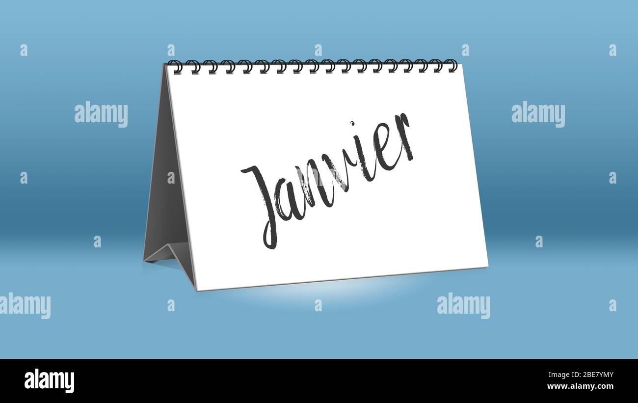 A calendar for the desk shows the French month of Janvier (January in English language) Stock Photo